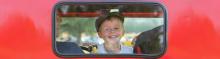 Boy peering out a car window