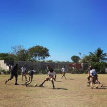 team playing soccer with the kids in merger