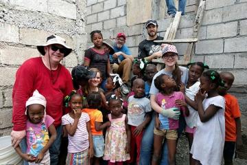 Team members with Haitian children