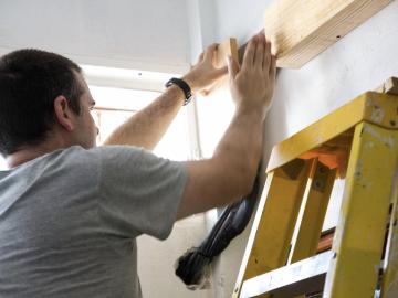 John working up a ladder