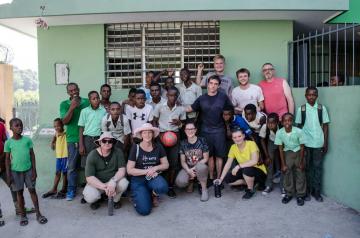 Team members with Haitian students after soccer