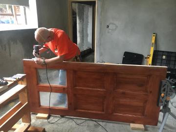 John working on a door