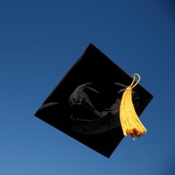 graduation cap in air